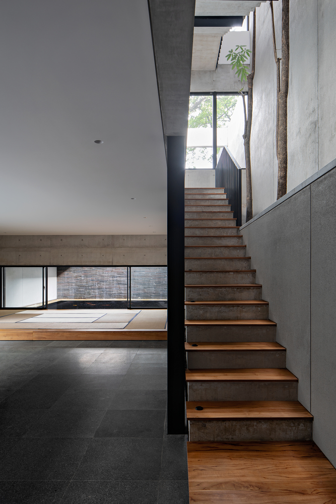 hideout house celebrates indoor-outdoor connection around a shallow ...